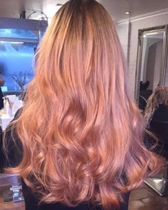 A woman with rose gold hair in a salon