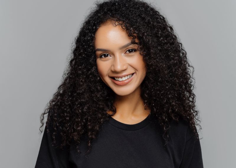 Girl with curly hair washed with frizz-control shampoo
