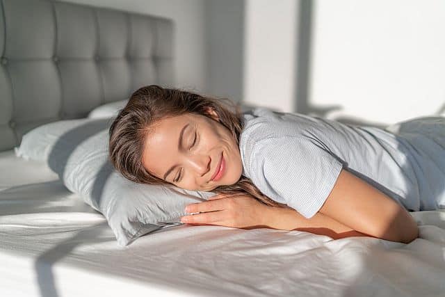 An Asian girl sleeping on a bamboo pillowcase