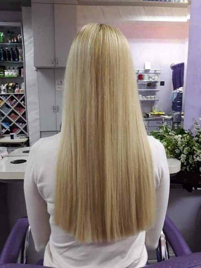 A blonde girl with amino acid straightened hair in the salon