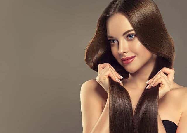 A model touching her keratin and collagen treated hair
