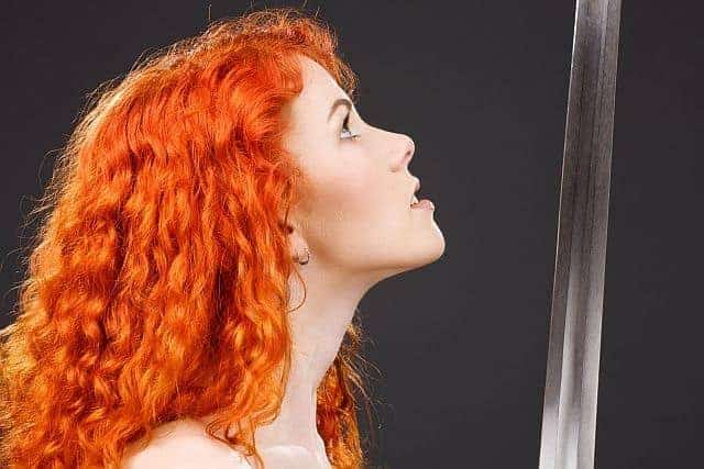 A woman with red-colored curly hair