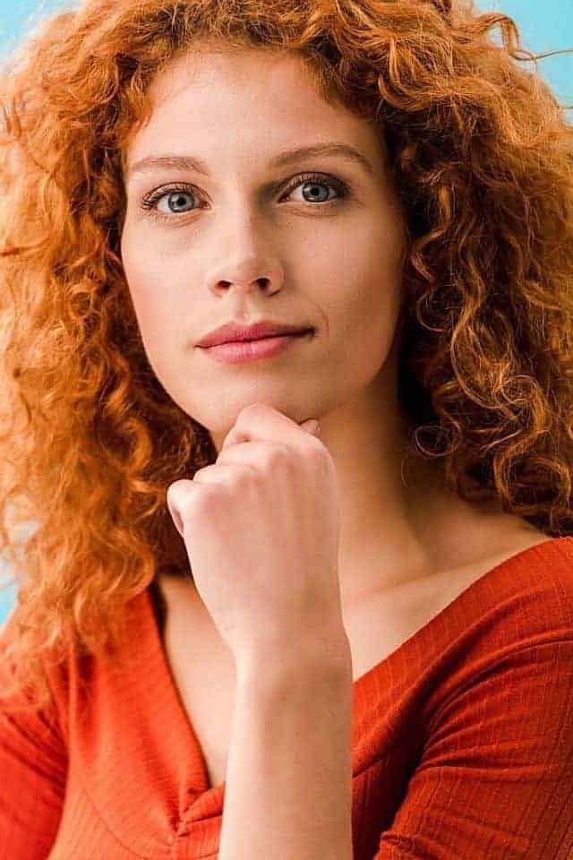A woman with red curly hair