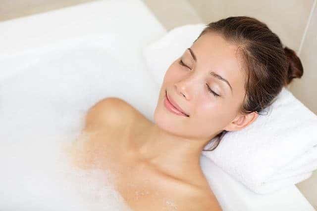 Asian woman relaxing in a bath