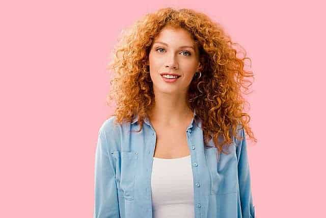 Attractive red-haired girl with curly hairstyle