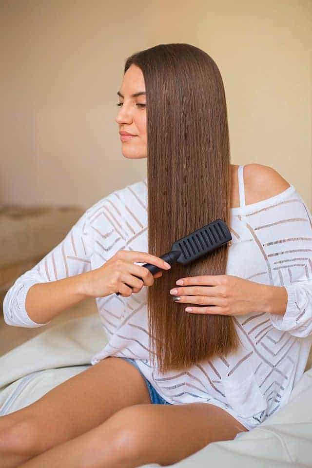 Girl brushing her keratin smoothened hair