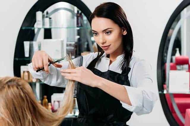 Hairdresser cutting split ends