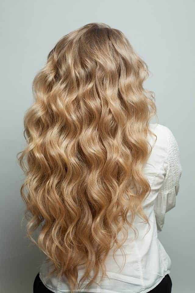 a blonde woman with long hair and beach waves