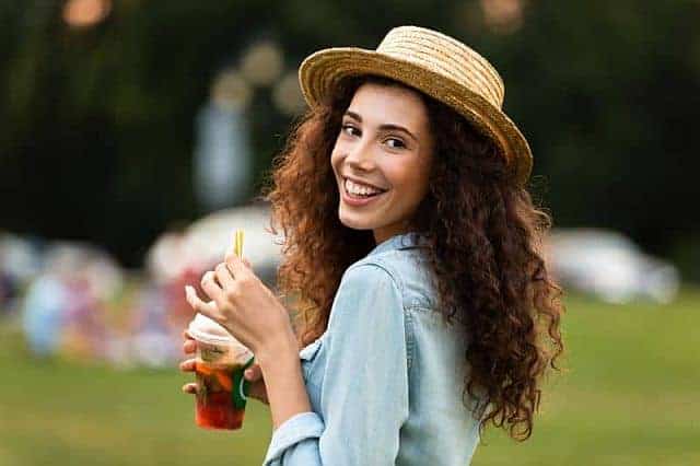 charming girl wearing a hat in the park