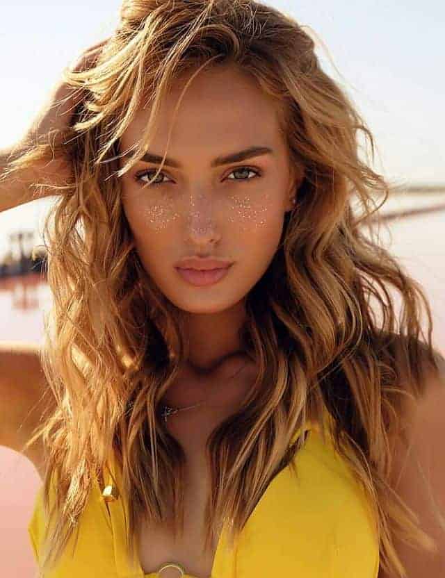 a gorgeous woman with beachy hair look after swimming in the ocean