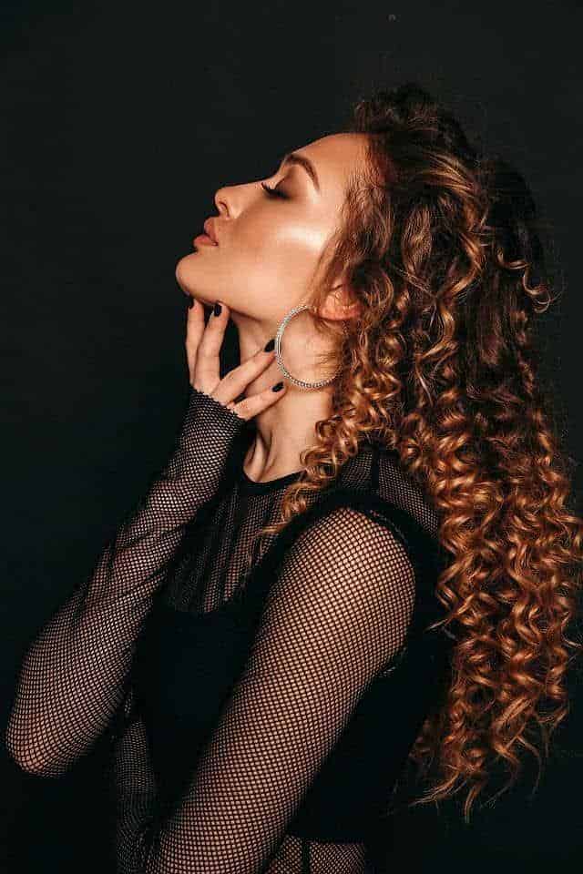 a gorgeous woman with spiral curls posing