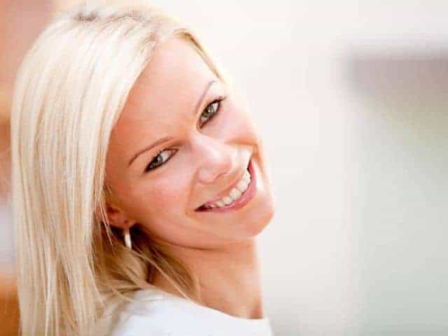 a smiling blonde woman with healthy hair