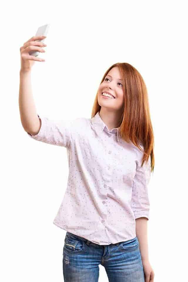 a young woman taking selfie after color service