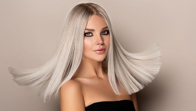 An elegant blonde woman with keratin-treated hair