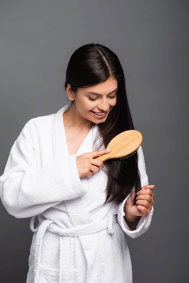 Woman combing her straight hair