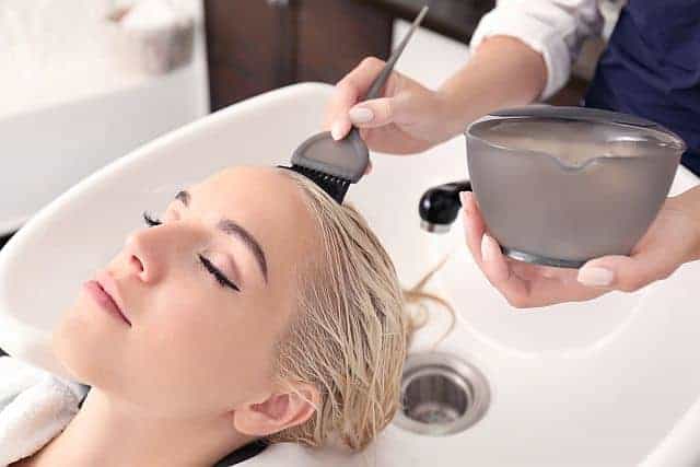 hairstylist performing Olaplex treatment in the salon