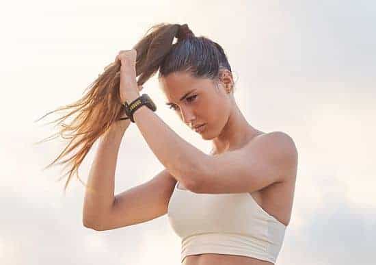 girl wearing ponytail while exercising