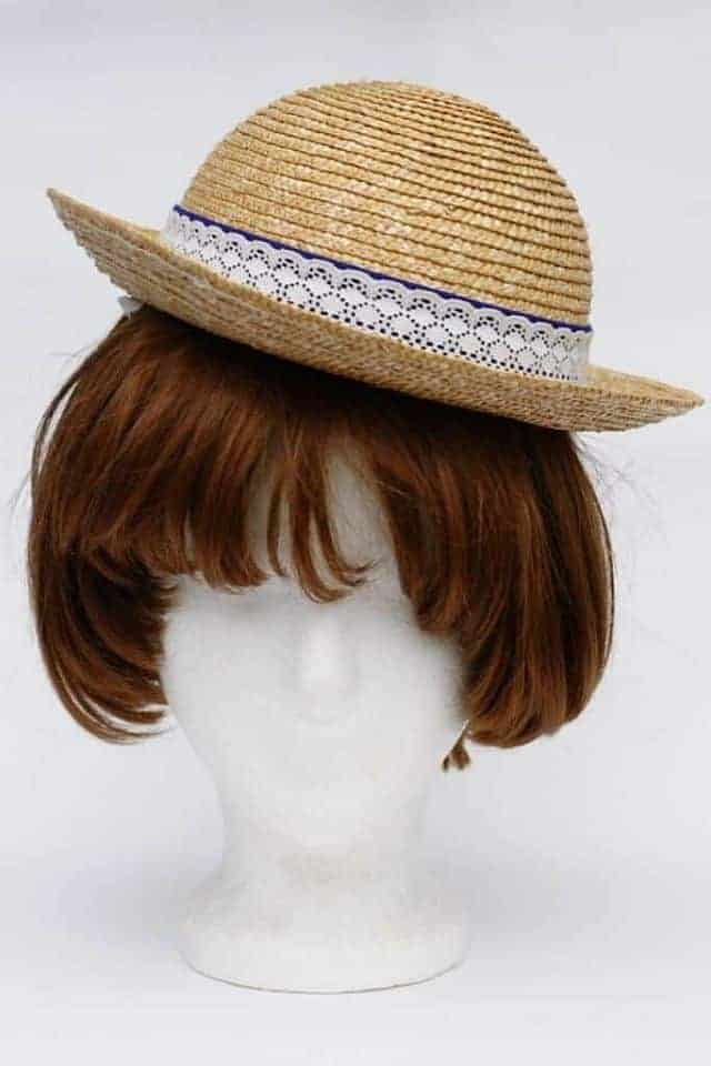 wig head with a wig and a hat