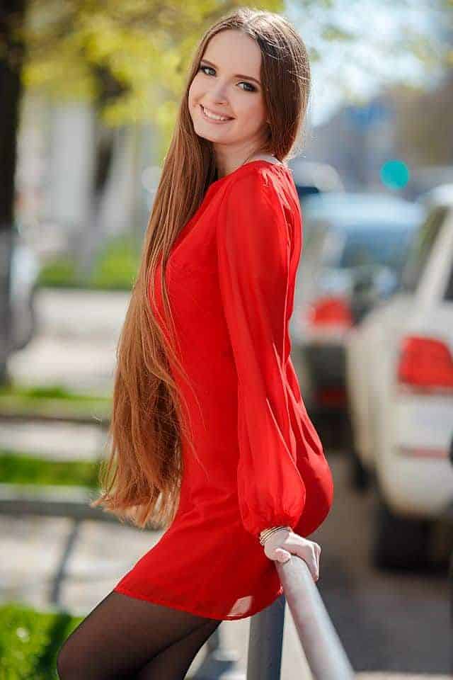A young beautiful woman with long hair wearing red dress