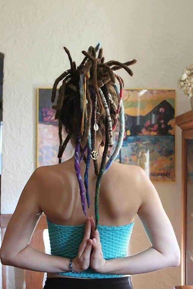 a young woman with dreadlock jewelry, backside