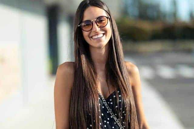 happy young woman with long straight hair 