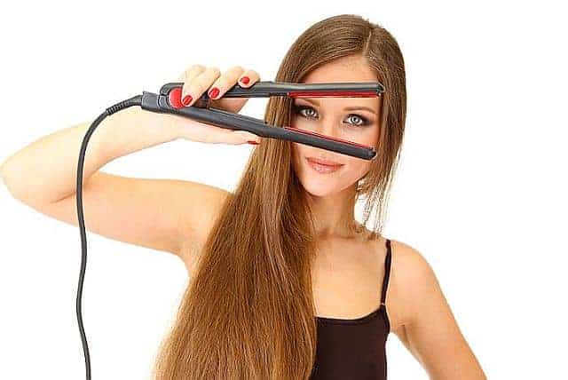 A woman holding hair straightener