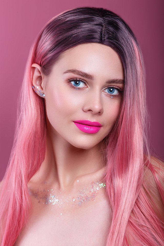 Beautiful woman wearing pink synthetic wig
