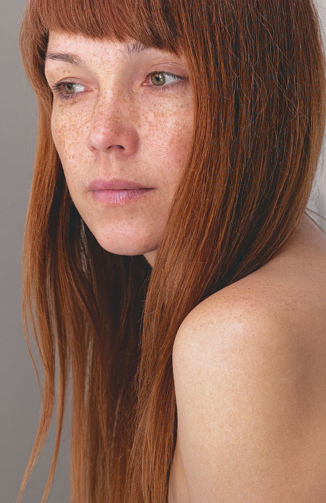 a woman with red hair after having root touch-up