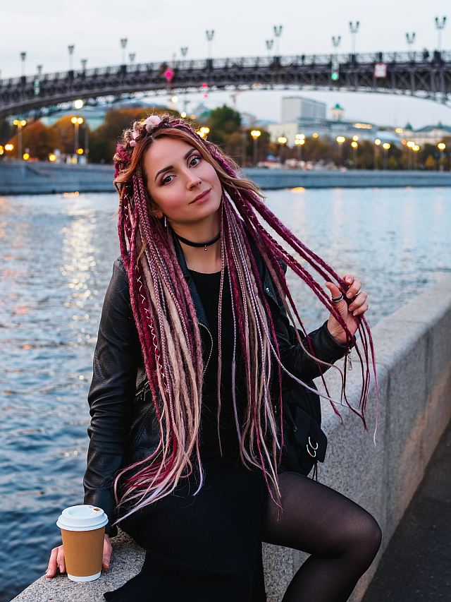 Beautiful young woman with long pink and beige dreadlocks