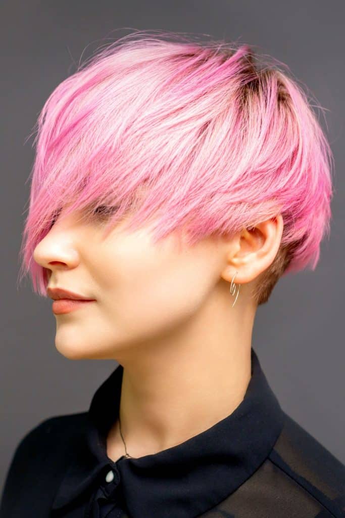 a woman with beautifully dyed pink hair in the salon