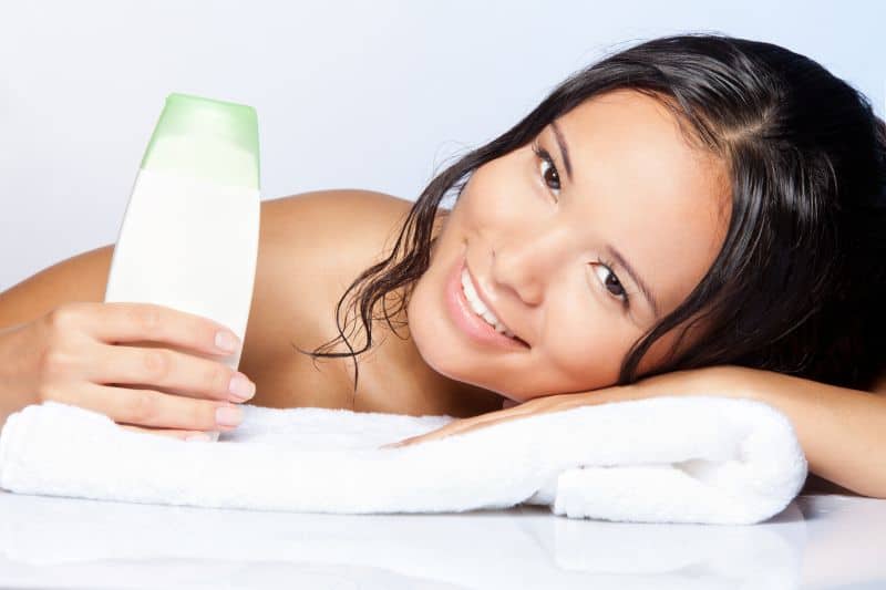 Brunette woman happy with hair softening shampoo
