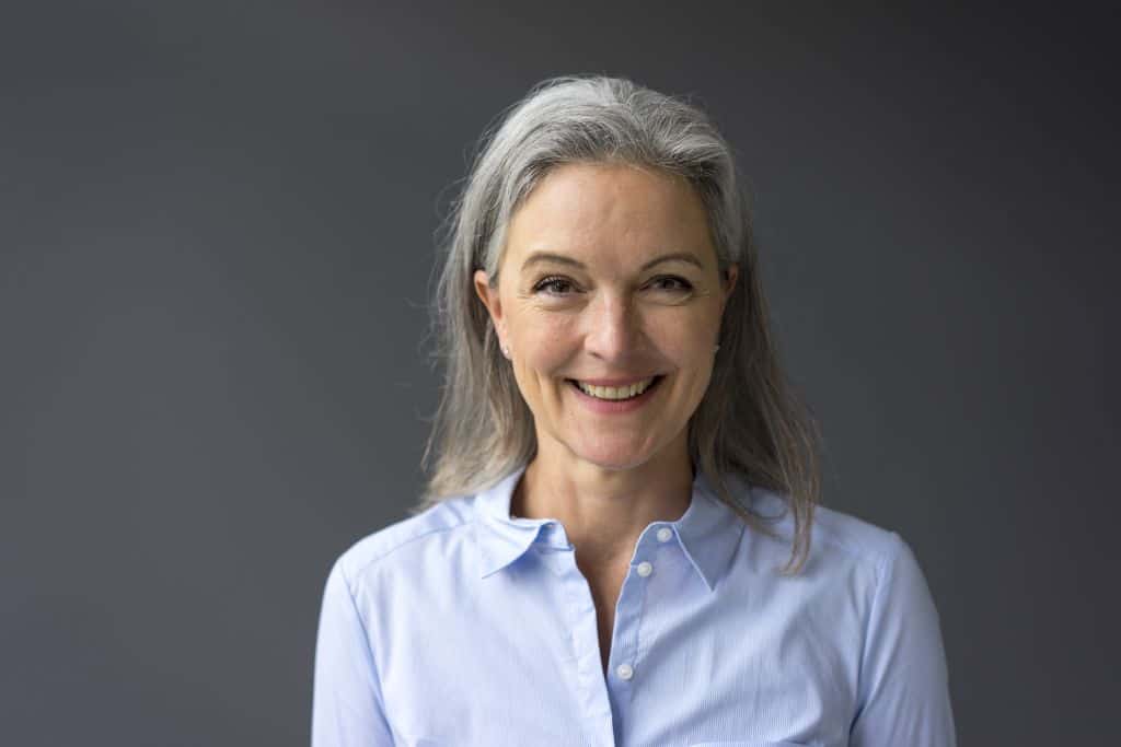 a woman with gray hair smiling