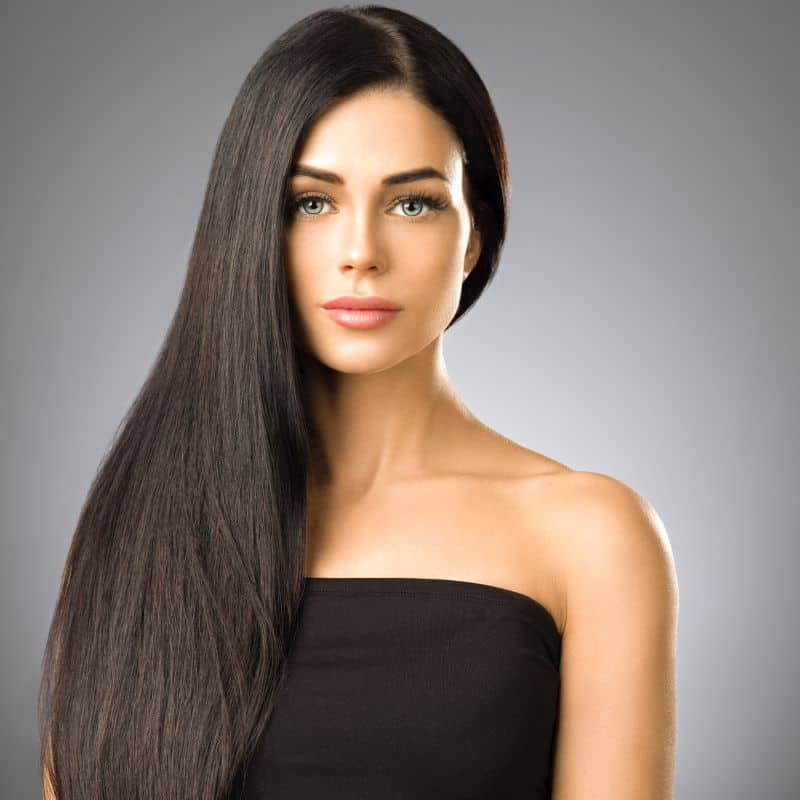 Beautiful brunette woman with long keratin straightened hair