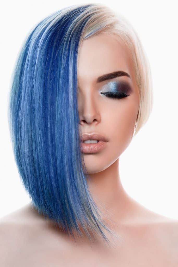 Beautiful woman with blue colored hair and closed eyes