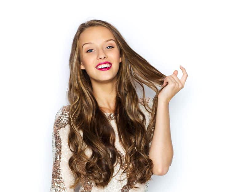 Happy young woman with wavy hairl in fancy dress