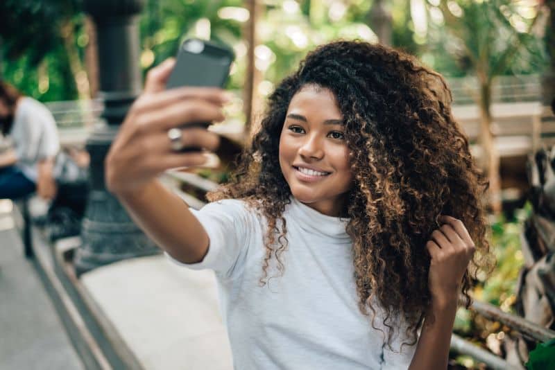 Young woman with afro hairstyle taking selfie