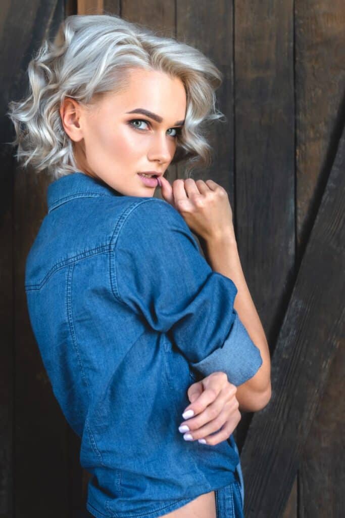 Attractive young woman in denim shirt with icy blonde hair