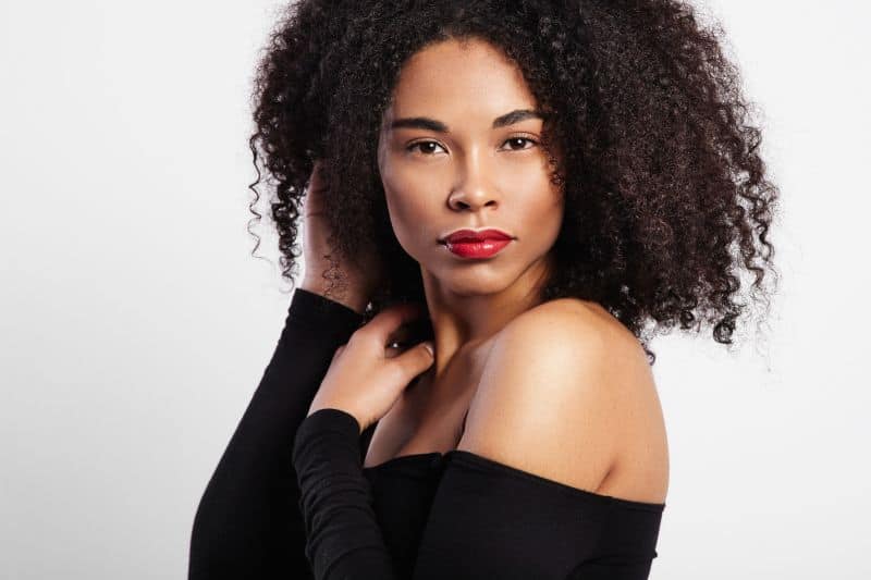 Black woman with curly hair and bright red lips