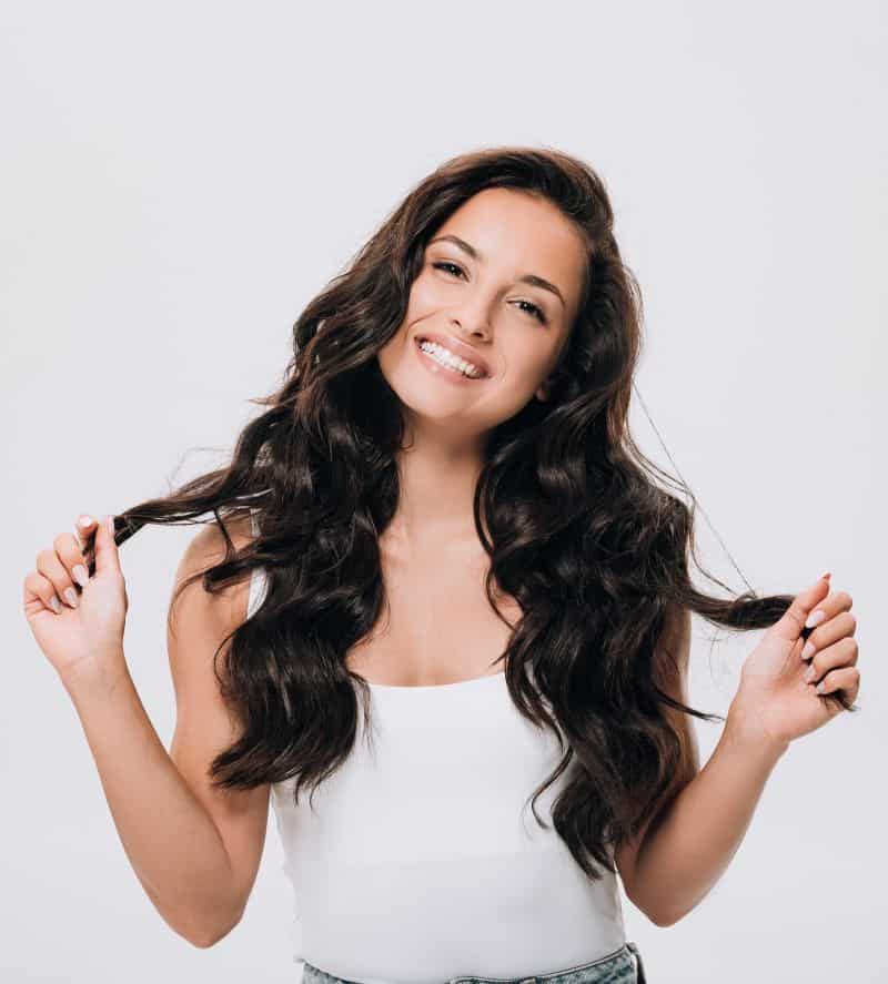 smiling brunette woman with long curly hair