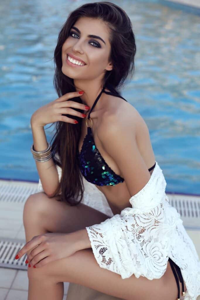 smiling woman with dark hair in swimming pool