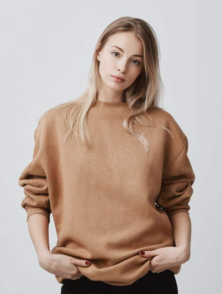 Cute blonde woman wearing loose sweater 