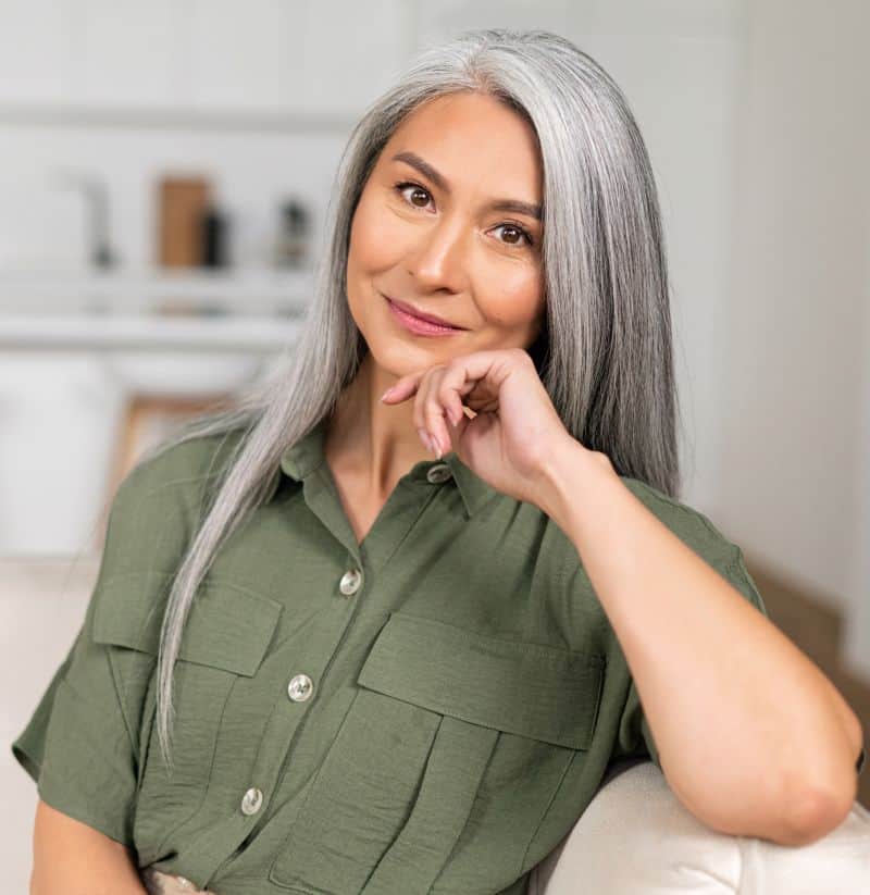 attractive middle-aged Asian woman with long silver hair