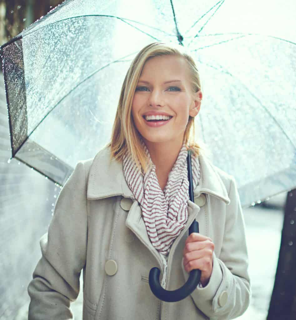 attractive young woman walking in the rain