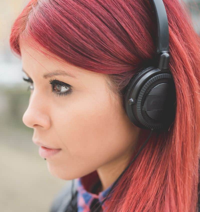 beautiful red hair girl listening music