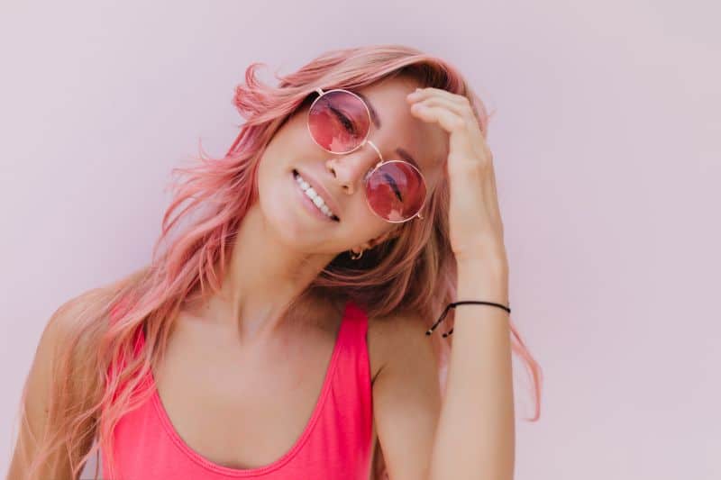 joyful caucasian woman with pink hair