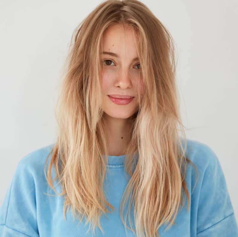 young blonde woman after blow-drying her hair