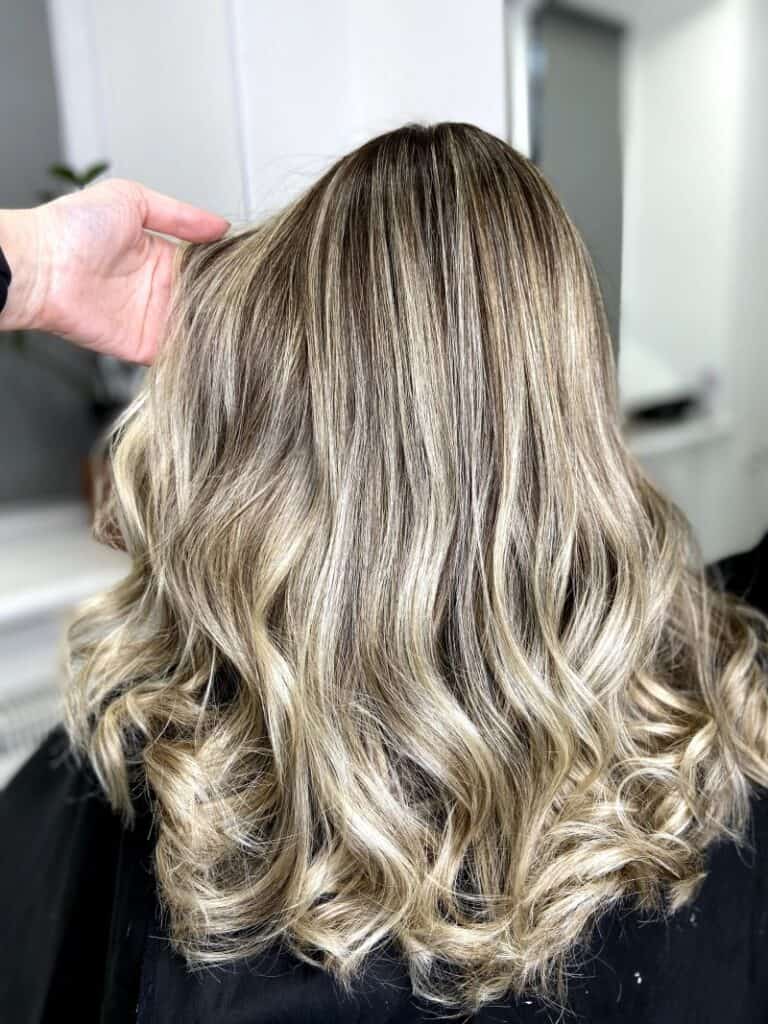 a woman with tbalayage hair in the salon