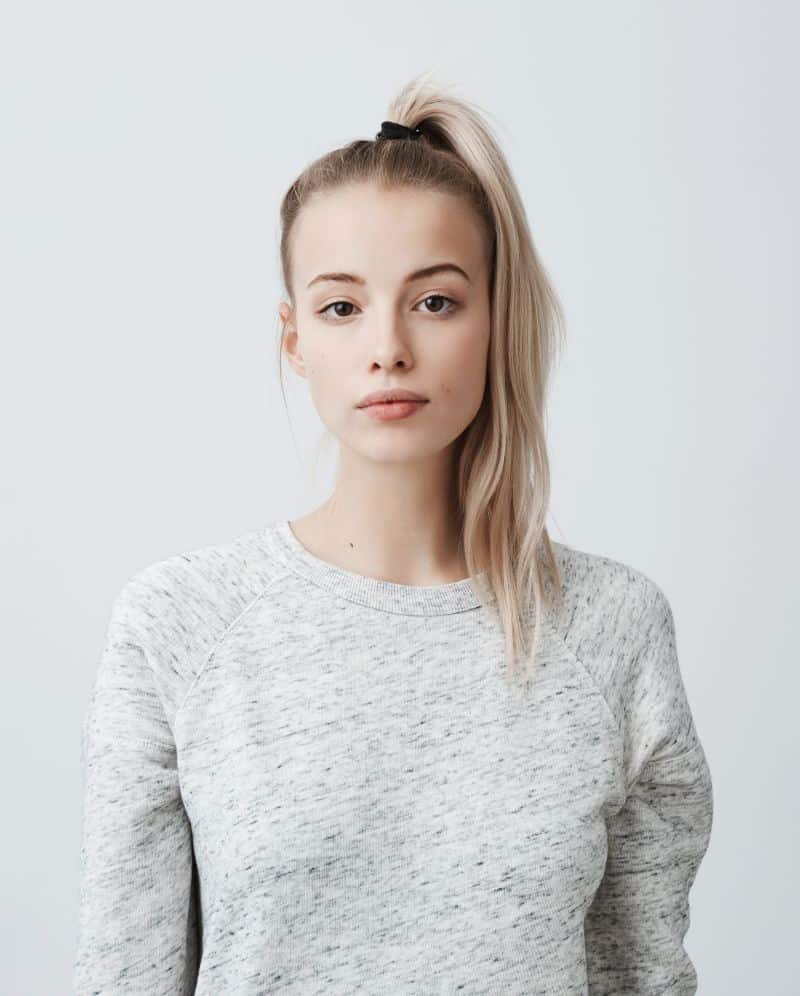 beautiful woman with fine blonde hair wearing pony tail